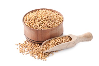 Mustard seeds with wooden bowl and scoop isolated on white