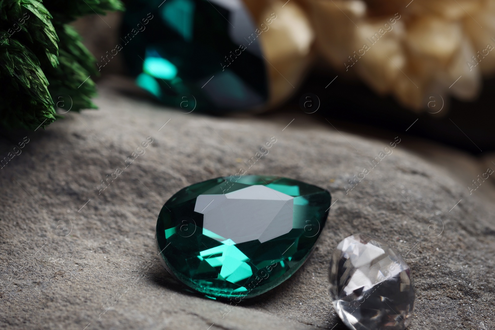 Photo of Two beautiful gemstones for jewelry on stone surface, closeup