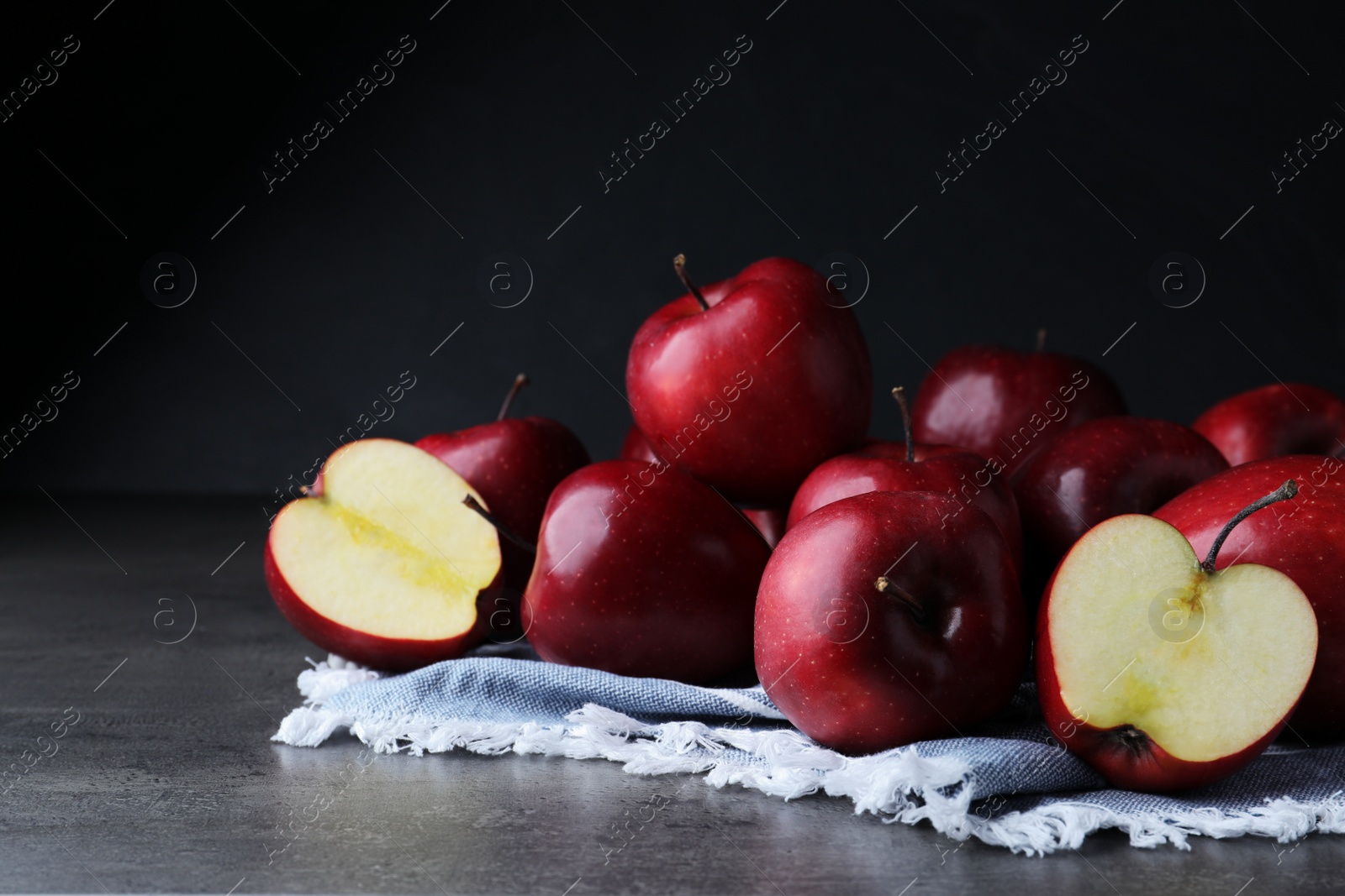 Photo of Fresh ripe red apples on grey table