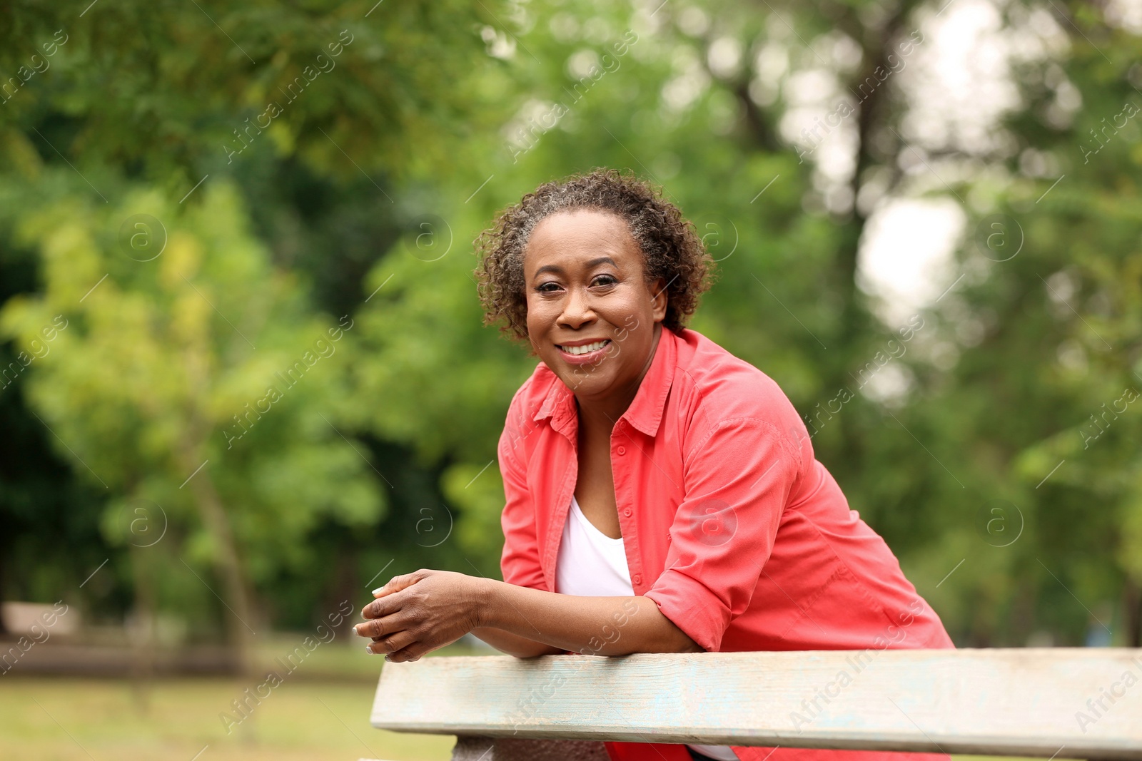 Photo of Portrait of happy African-American woman in park