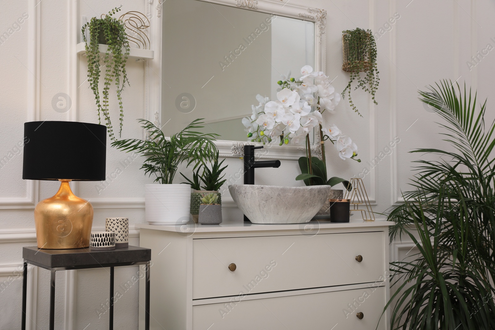 Photo of Stylish bathroom interior with modern furniture and beautiful houseplants