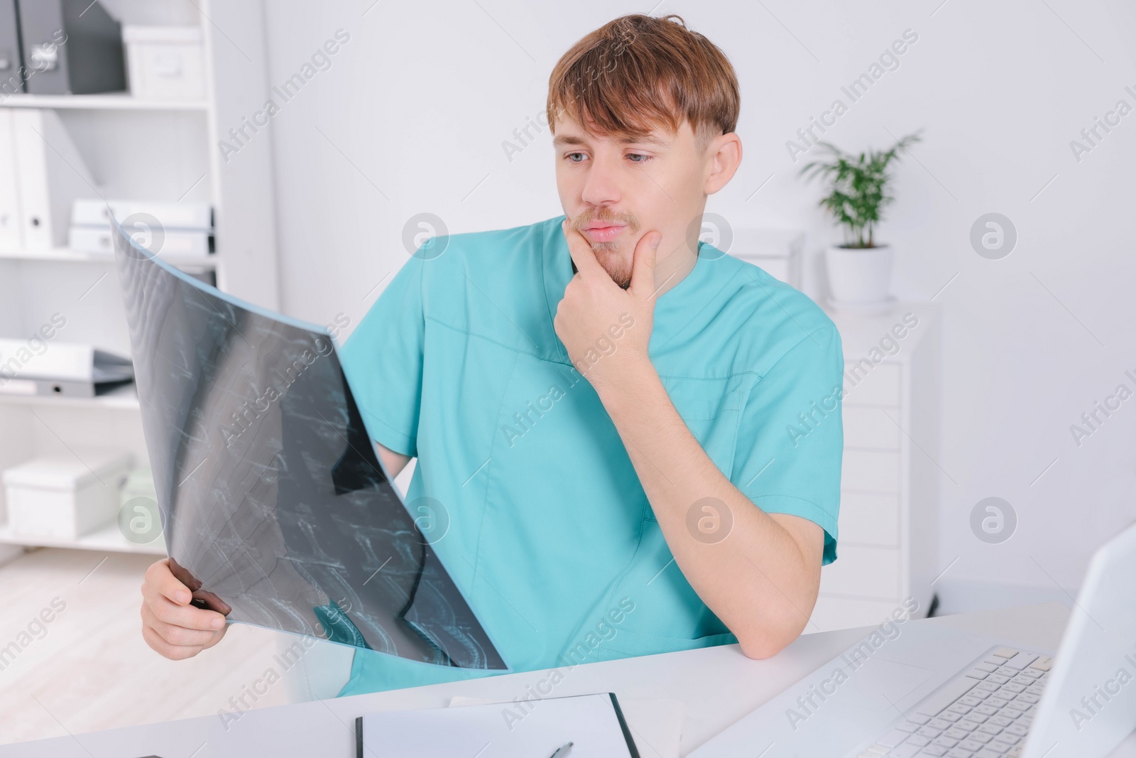 Photo of Doctor examining neck MRI image in clinic