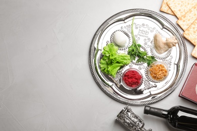 Photo of Flat lay composition with symbolic Passover (Pesach) items on color background, space for text