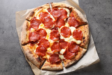 Tasty pepperoni pizza on grey table, top view