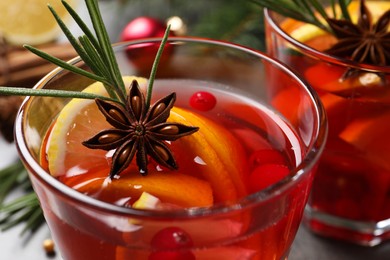 Glass with delicious punch drink on table, closeup