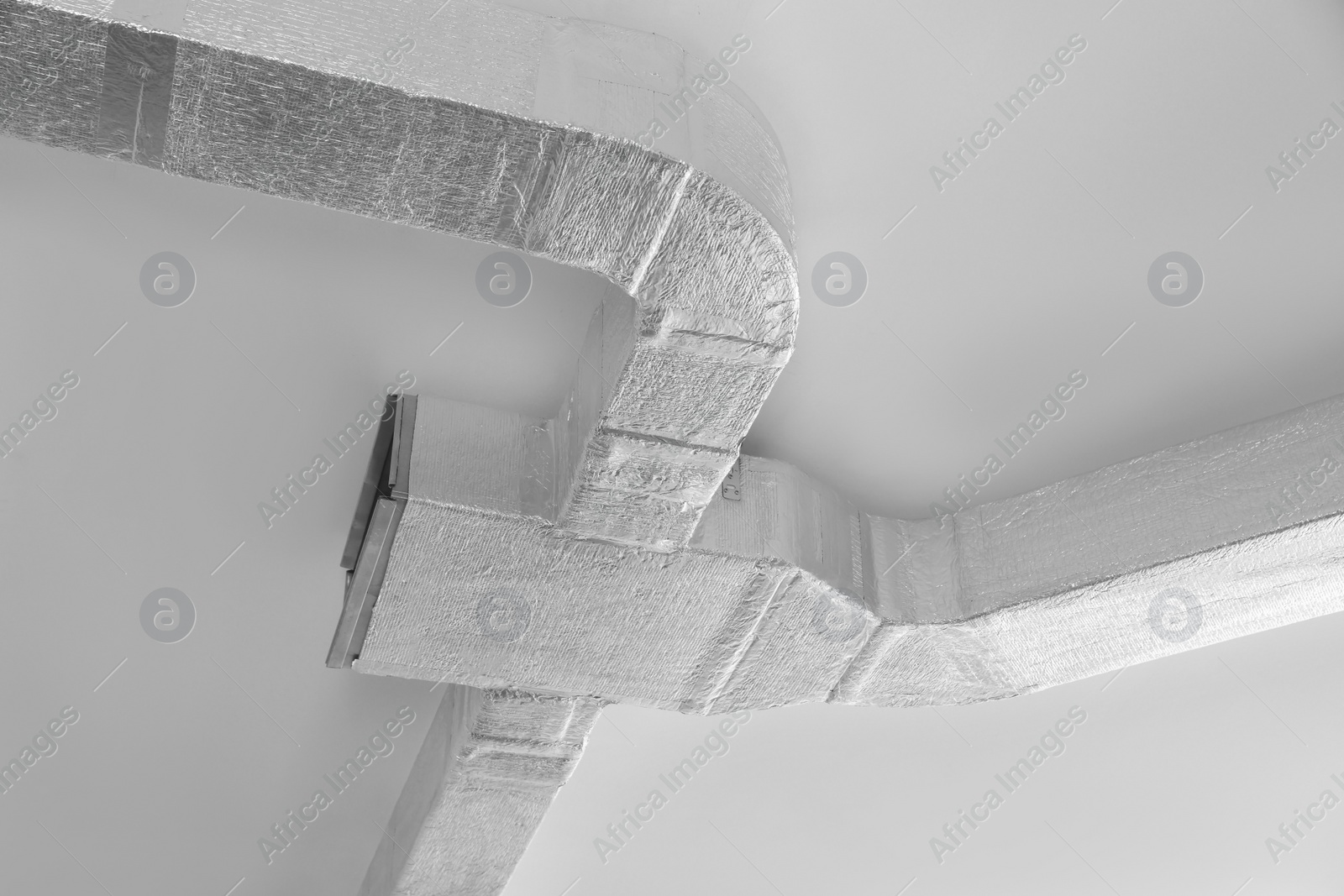 Photo of Ceiling with ventilation system indoors, low angle view