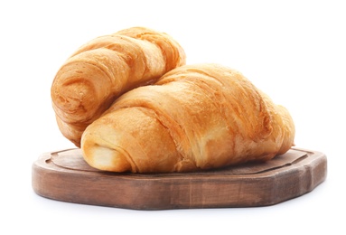 Wooden board with tasty croissants on white background