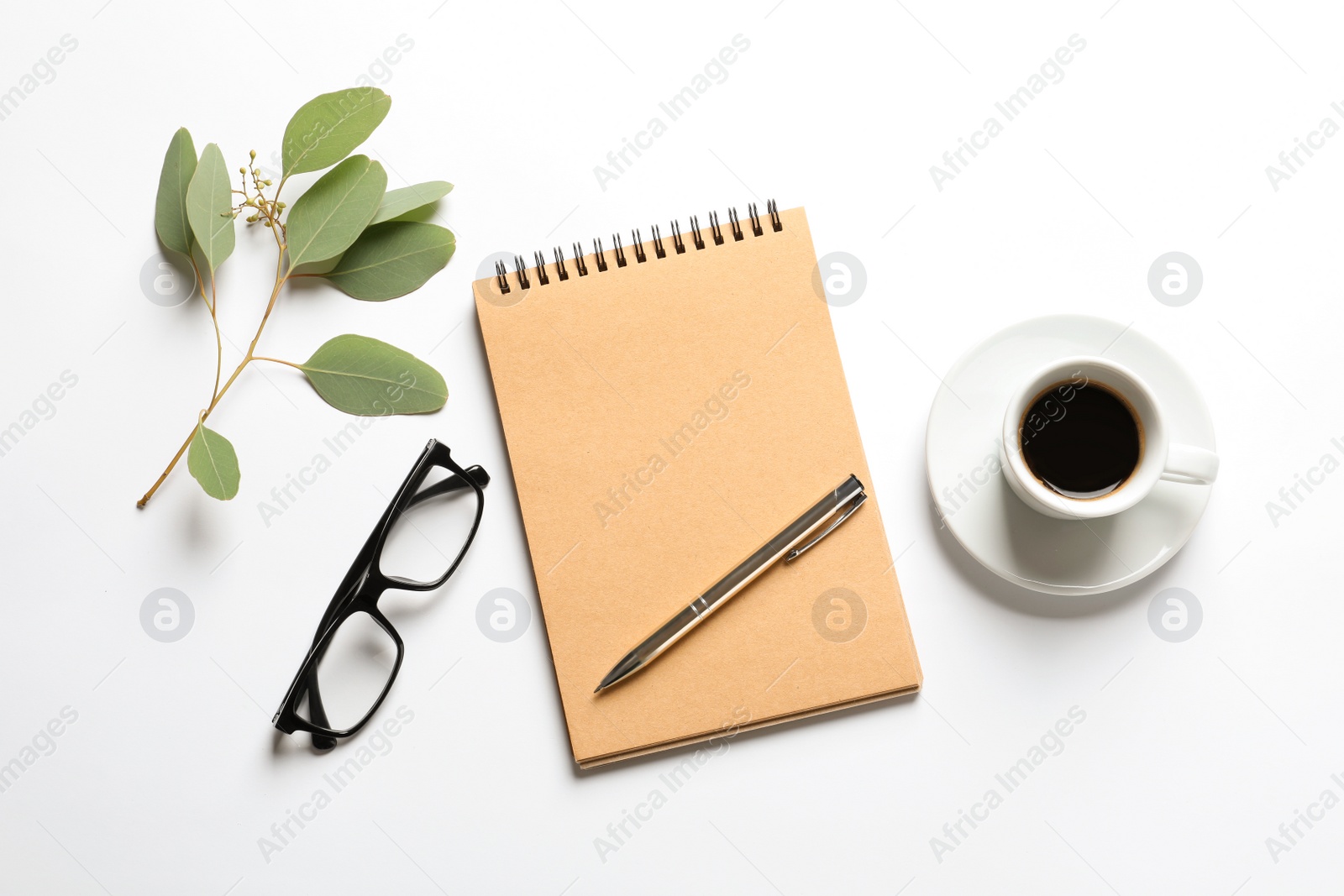 Photo of Flat lay composition with notebook, cup of coffee and glasses on white background