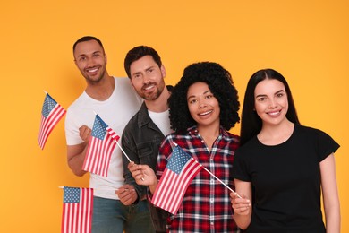 4th of July - Independence Day of USA. Happy friends with American flags on yellow background