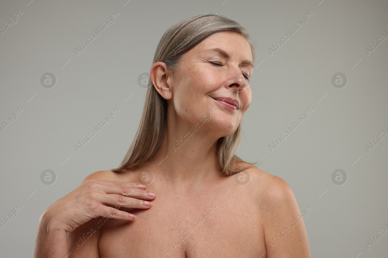 Photo of Beautiful woman with healthy skin on grey background