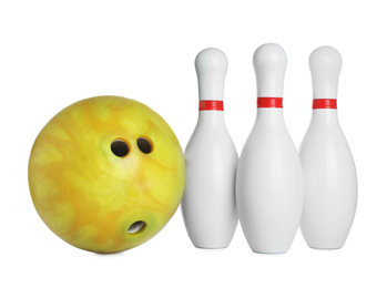 Photo of Yellow bowling ball and pins isolated on white