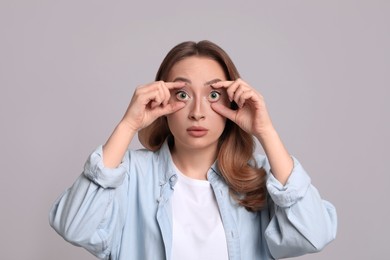 Photo of Woman with yellow eyes on grey background. Liver problems symptom