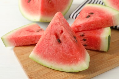 Photo of Delicious fresh watermelon slices on white table, closeup