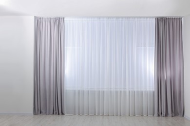 Light grey window curtains and white tulle indoors