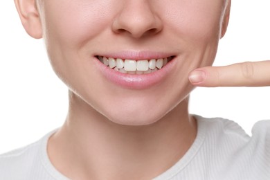 Woman showing healthy gums on white background, closeup