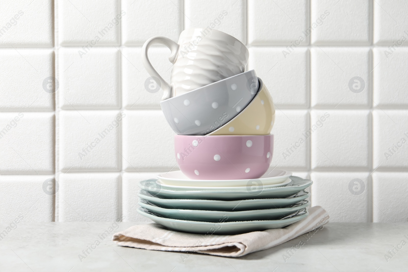 Photo of Beautiful ceramic dishware and cup on light grey table