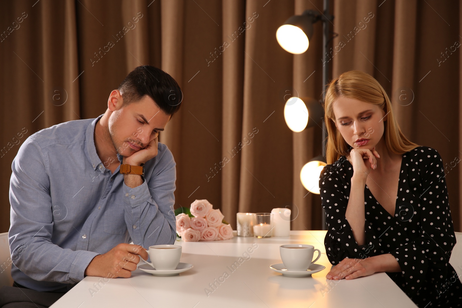 Photo of Displeased man and young woman in restaurant. Failed first date