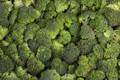 Photo of Fresh raw broccoli as background, top view