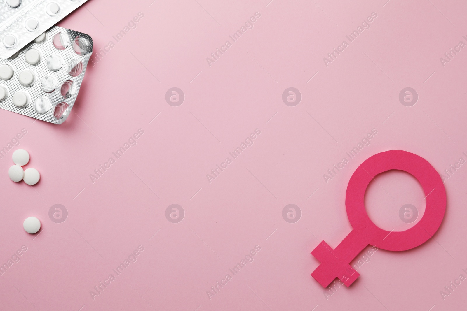 Photo of Female gender sign, pills and space for text on pink background, flat lay. Women's health concept