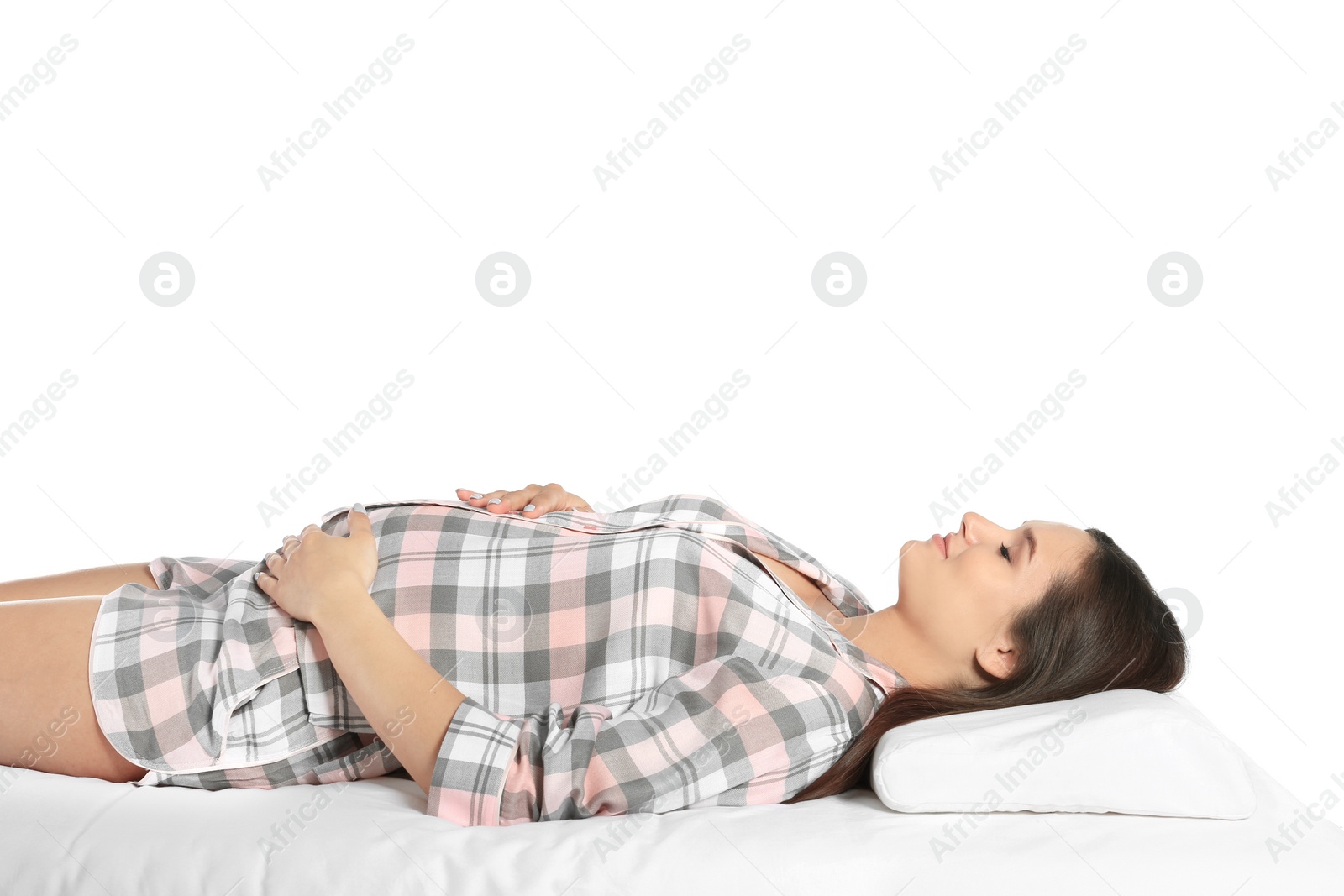 Photo of Beautiful pregnant woman sleeping with orthopedic pillow on bed against white background