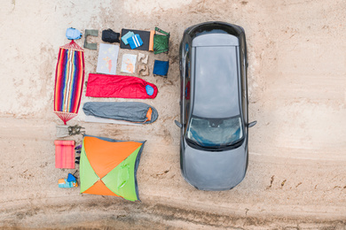 Image of Car and camping equipment on sandy beach, aerial view. Summer trip