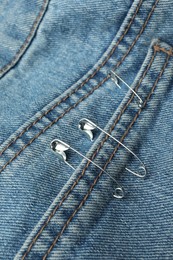 Closeup view of metal safety pins on clothing