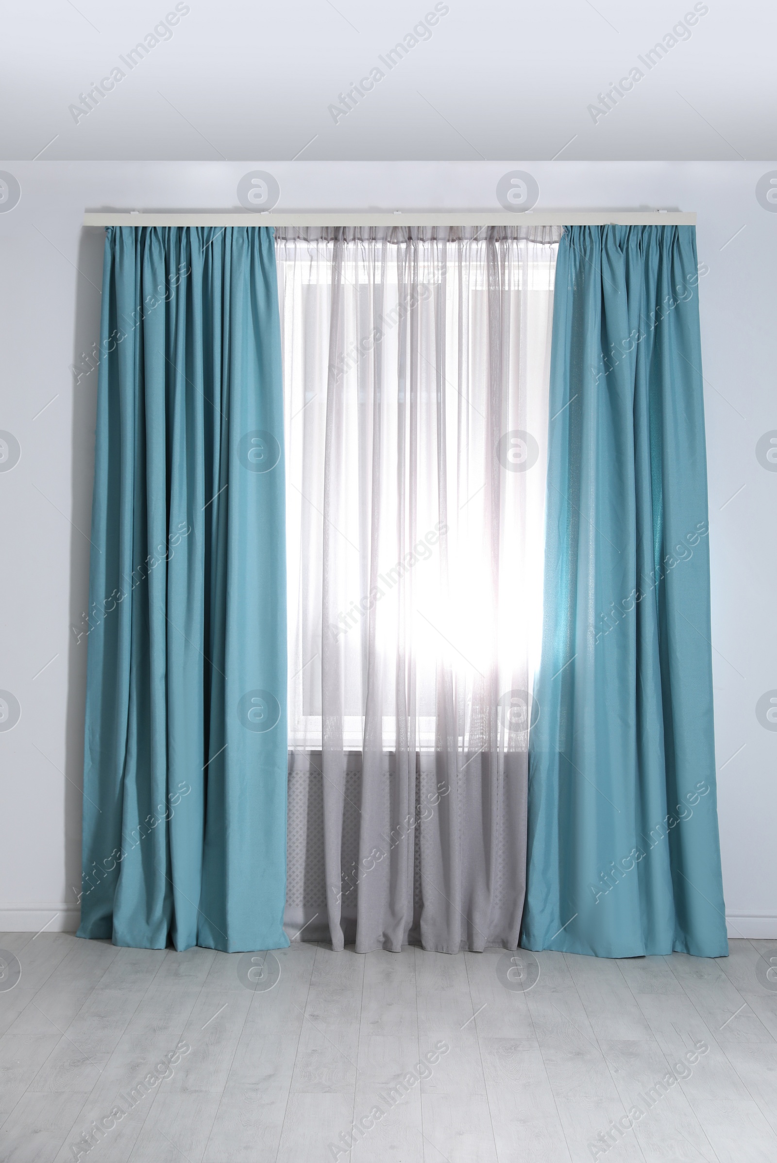 Photo of Window with elegant curtains in empty room