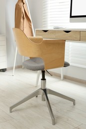 Stylish office chair at workplace in room. Interior design