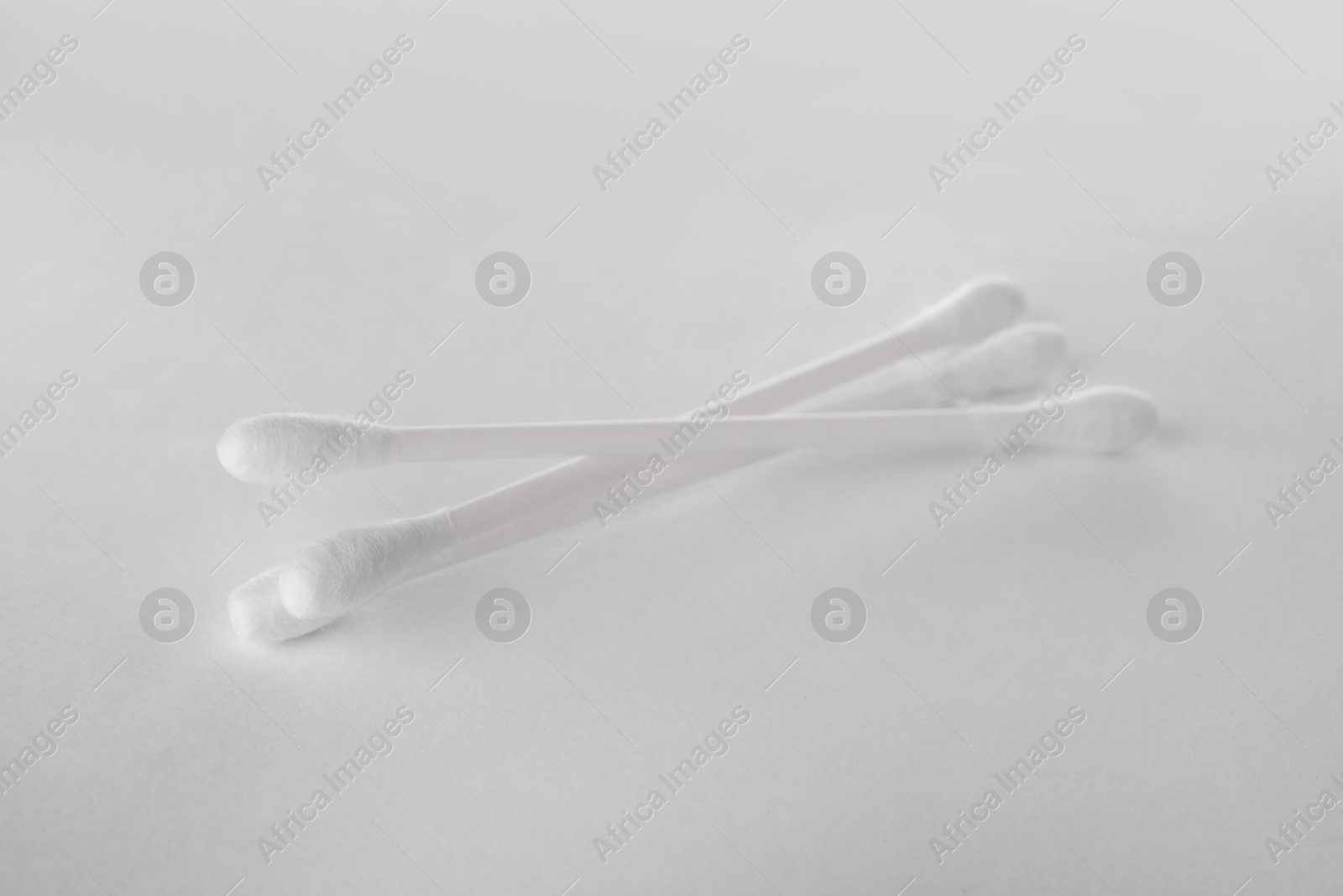 Photo of Clean cotton buds on white background. Hygienic accessory