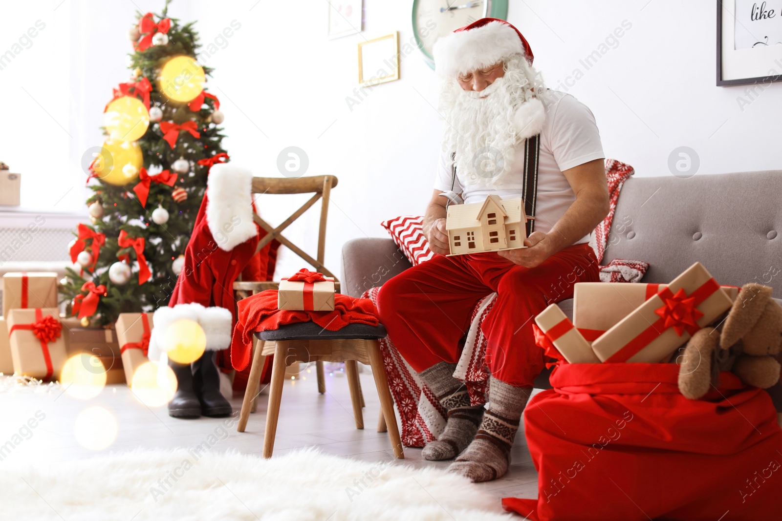 Photo of Authentic Santa Claus making toy in workshop