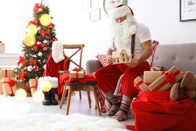 Authentic Santa Claus making toy in workshop