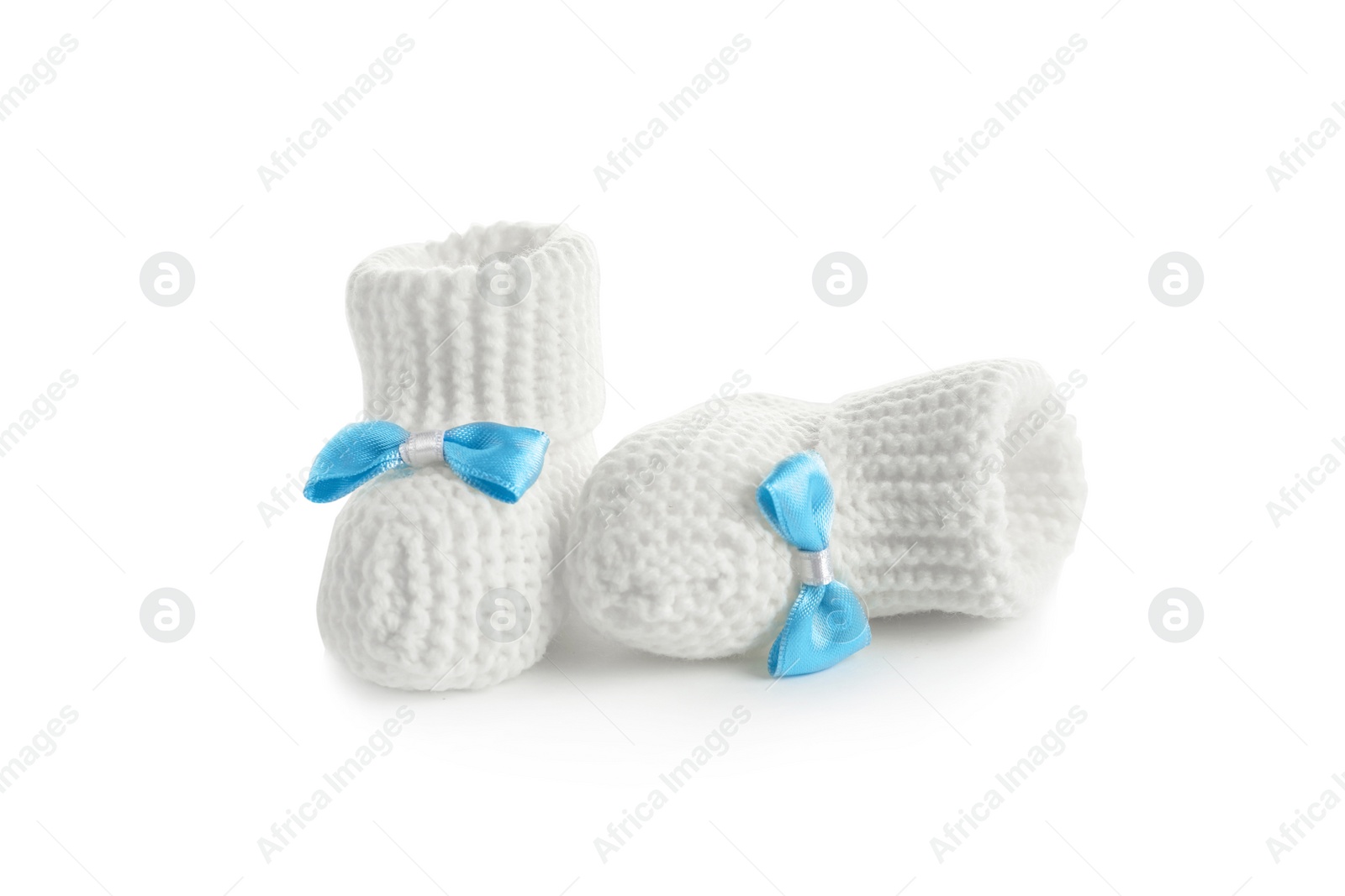 Photo of Handmade baby booties with bows isolated on white