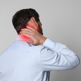 Man suffering from rheumatism on light background