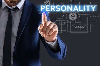 Man pointing at word PERSONALITY on virtual screen against dark background, closeup 
