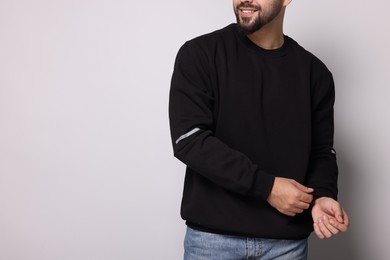 Photo of Man in stylish sweater on white background, closeup. Space for text