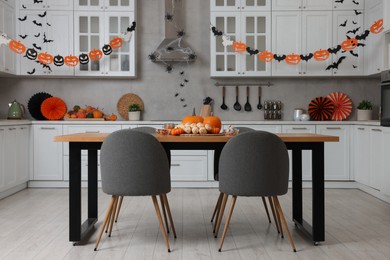 Photo of Stylish kitchen interior with festive decor. Halloween celebration