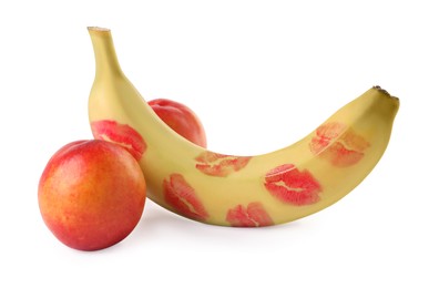 Photo of Banana with red lipstick marks and nectarines symbolizing male genitals on white background. Potency concept