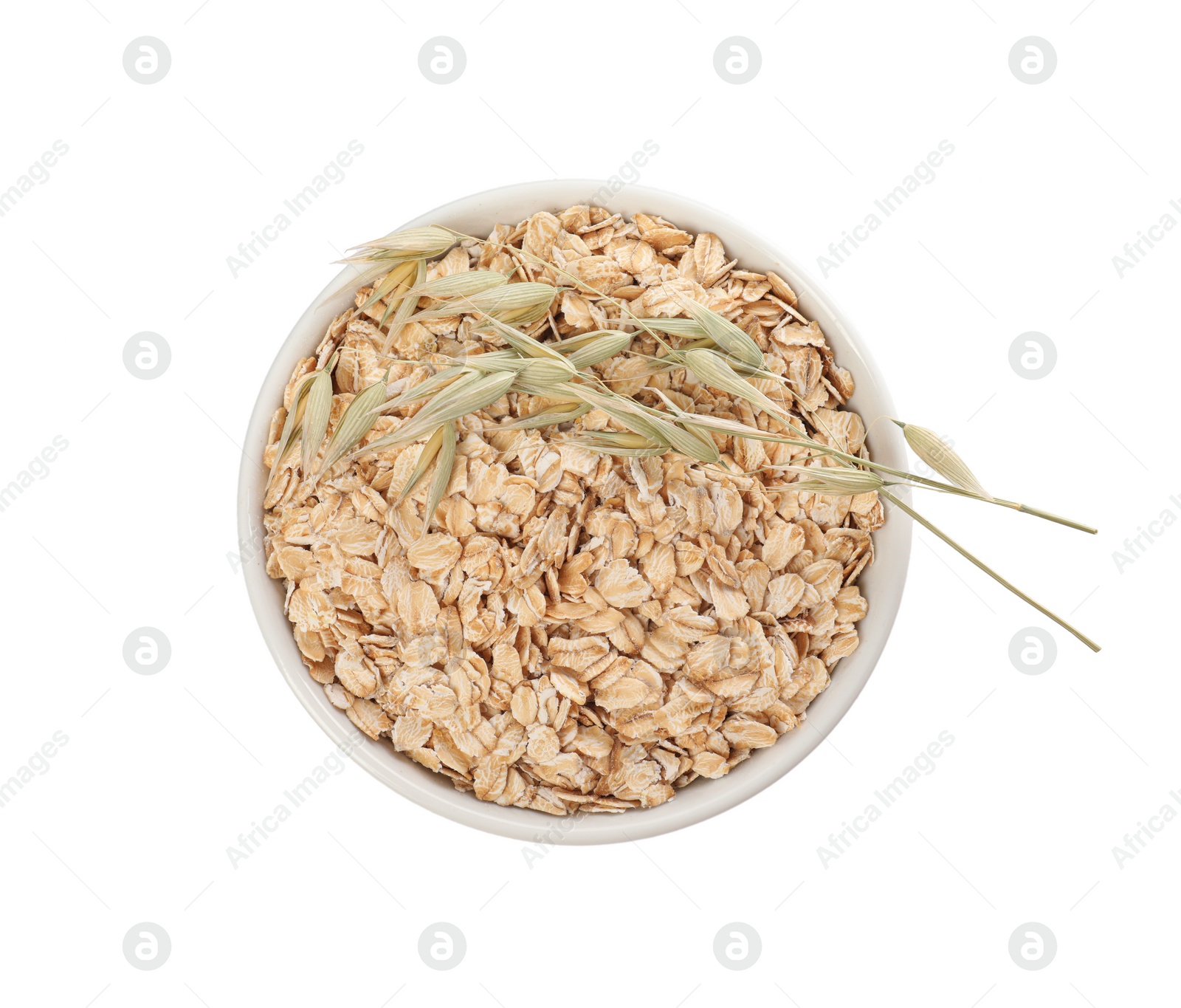 Photo of Bowl of oatmeal and branches with florets isolated on white, top view