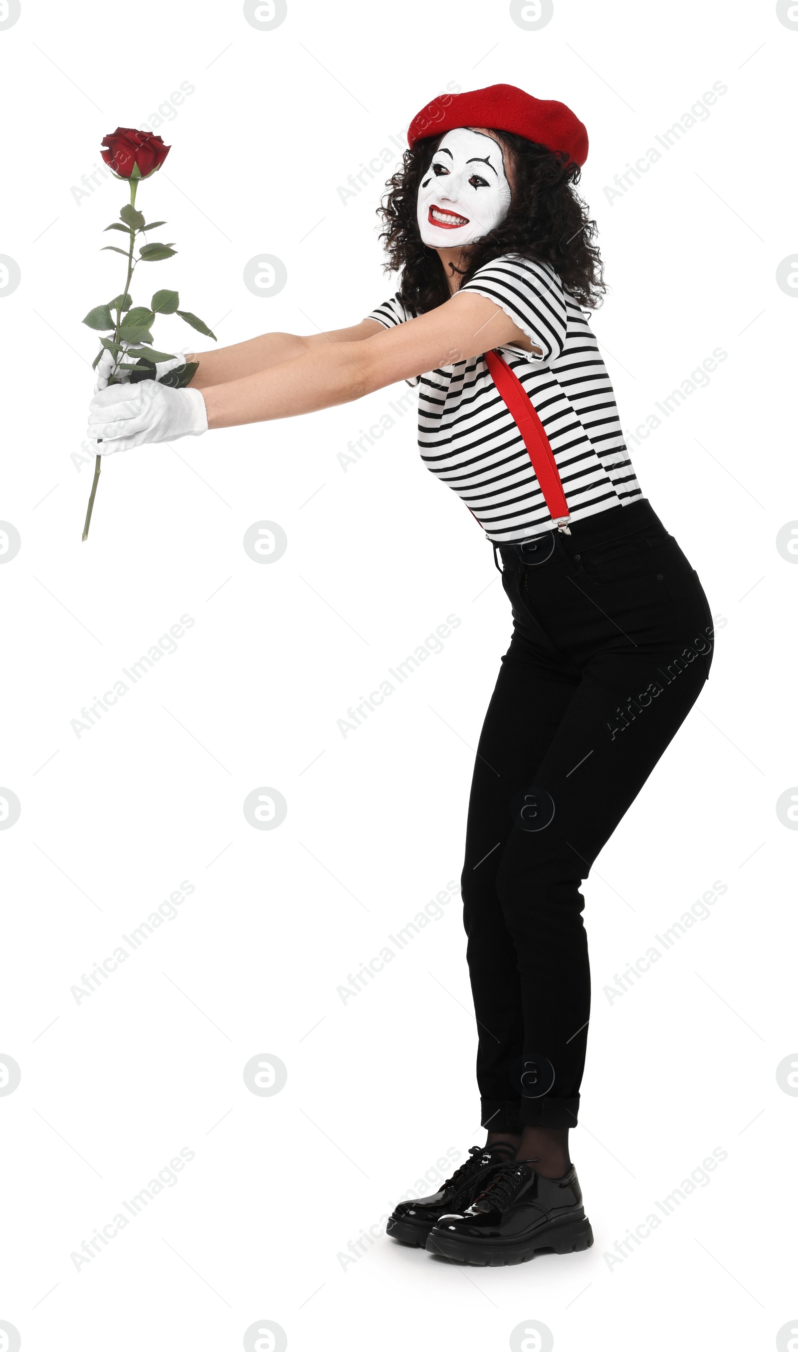 Photo of Funny mime with red rose posing on white background