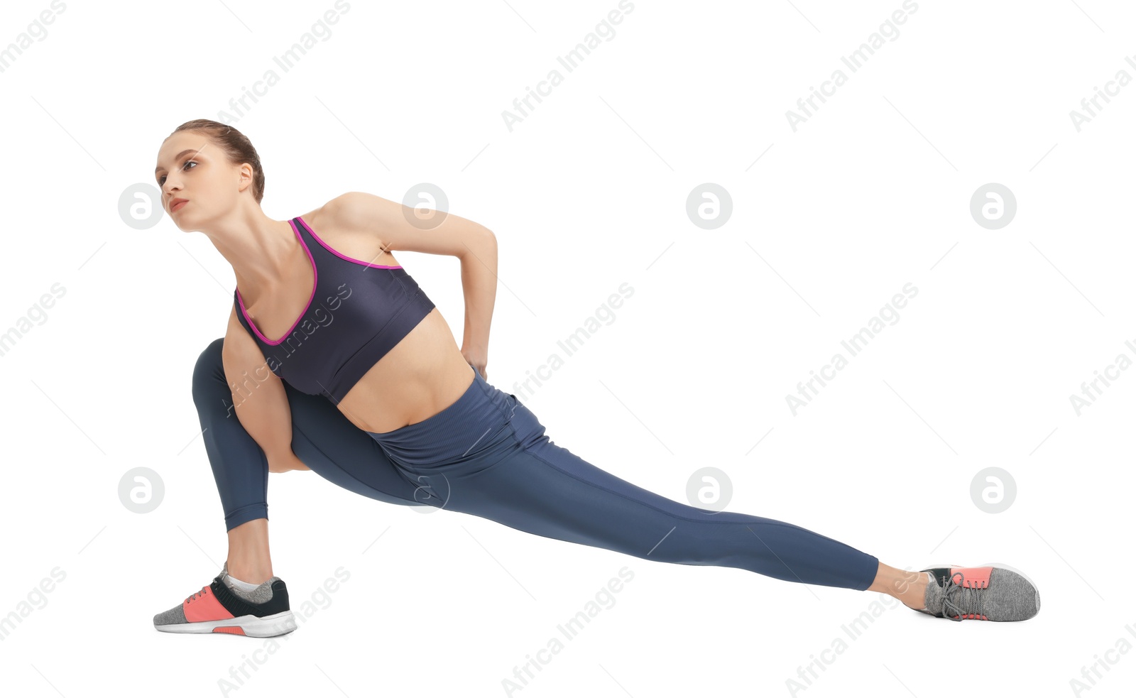 Photo of Yoga workout. Young woman stretching on white background