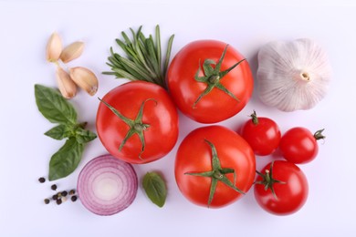 Flat lay composition with different ripe red tomatoes on white background