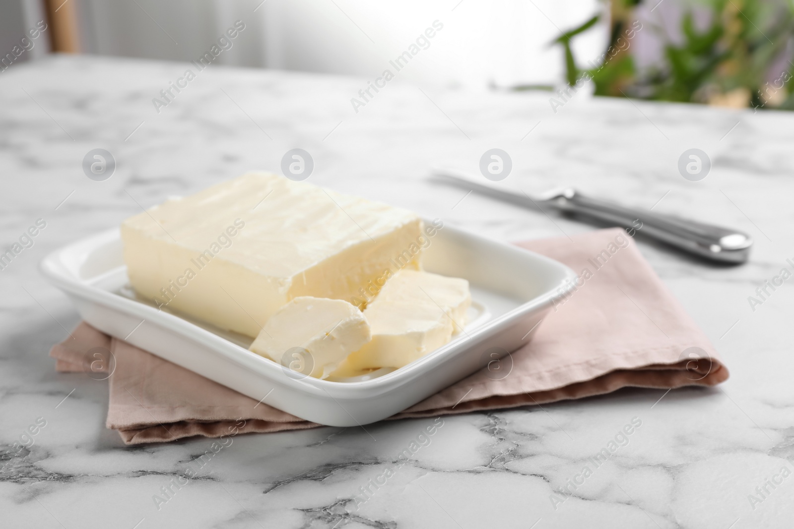 Photo of Dish with tasty fresh butter on table