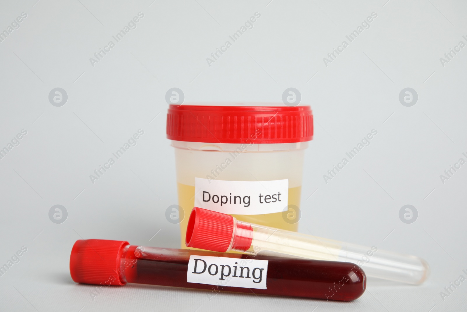 Photo of Jar and test tubes with samples on light grey background. Doping control