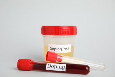 Jar and test tubes with samples on light grey background. Doping control