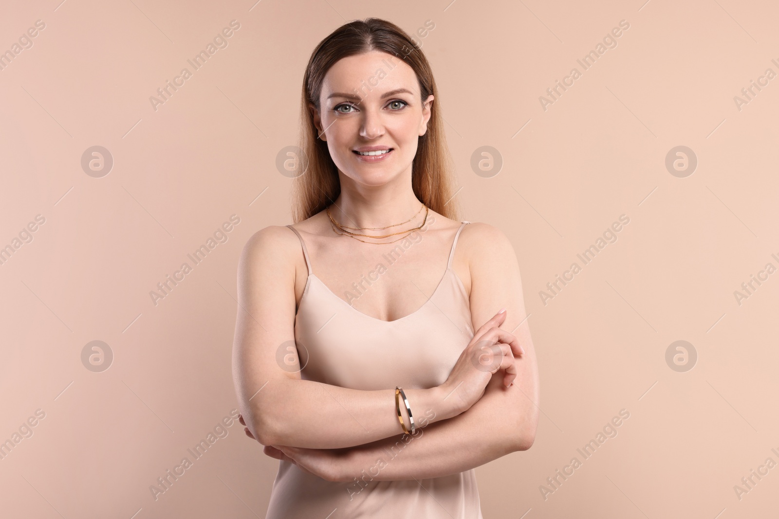 Photo of Beautiful woman with elegant jewelry on beige background