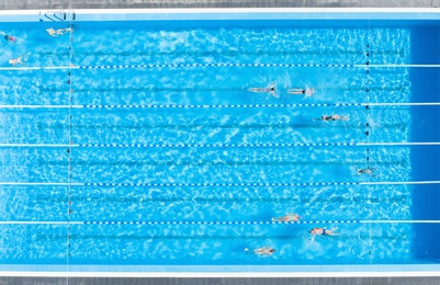 Image of People training in outdoor swimming pool, top view