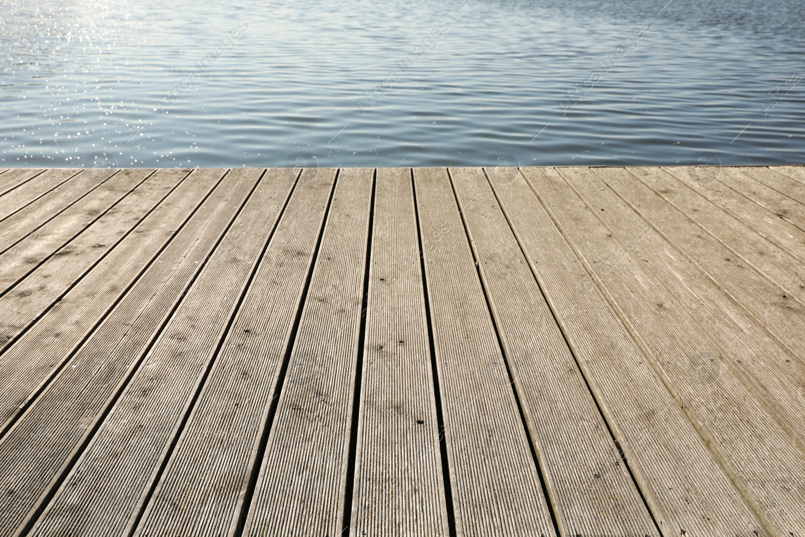 Photo of Beautiful view of wooden terrace near river on sunny day