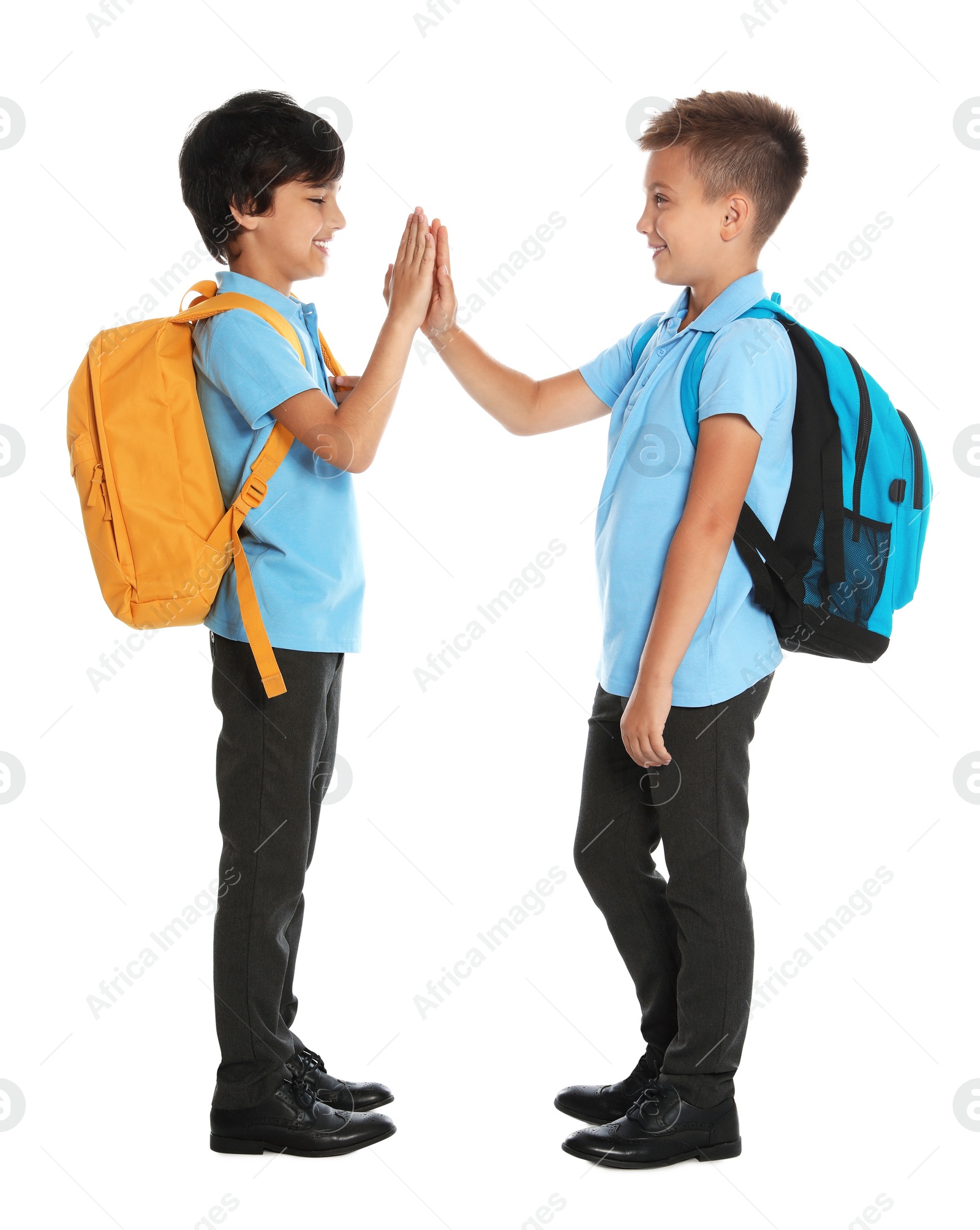 Photo of Happy boys in school uniform on white background