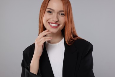 Portrait of beautiful young woman on light gray background