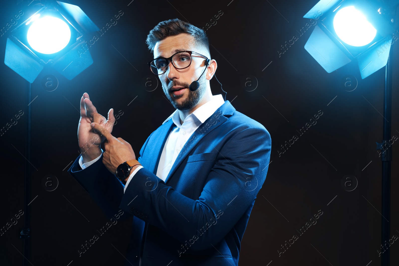 Photo of Motivational speaker with headset performing on stage